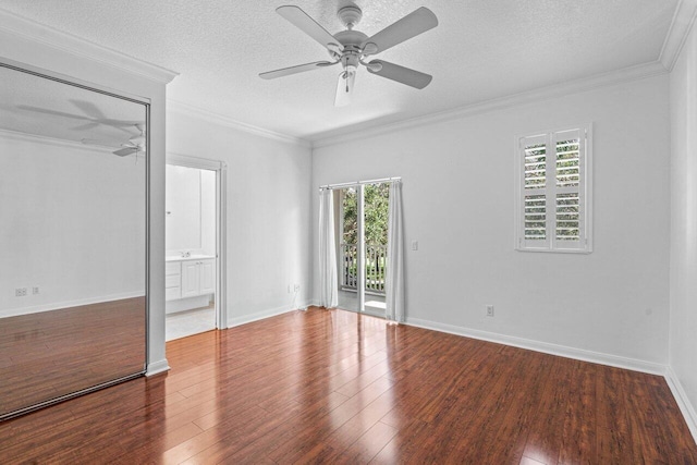 unfurnished bedroom featuring a textured ceiling, access to outside, crown molding, and wood finished floors