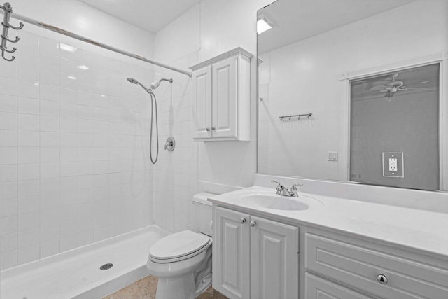 full bath featuring toilet, a tile shower, and vanity