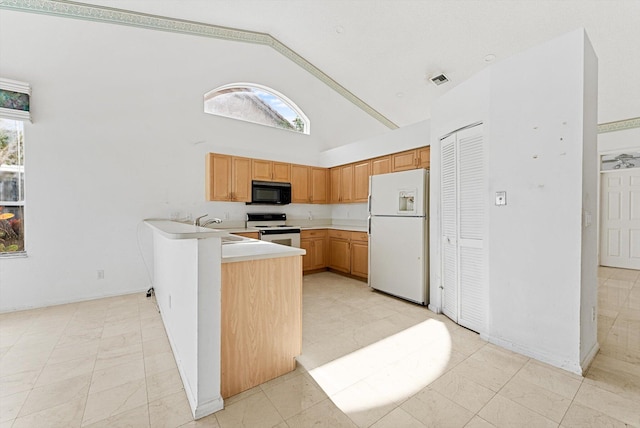 kitchen featuring high vaulted ceiling, a wealth of natural light, kitchen peninsula, and white appliances