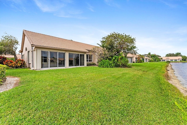 rear view of property with a yard