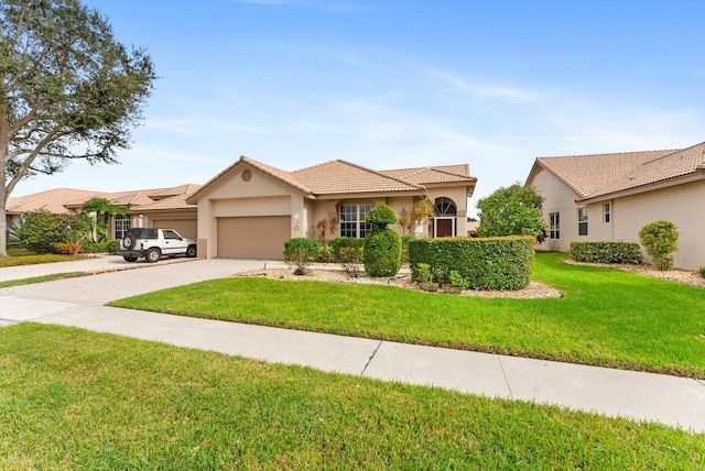 view of front of property with a garage and a front lawn