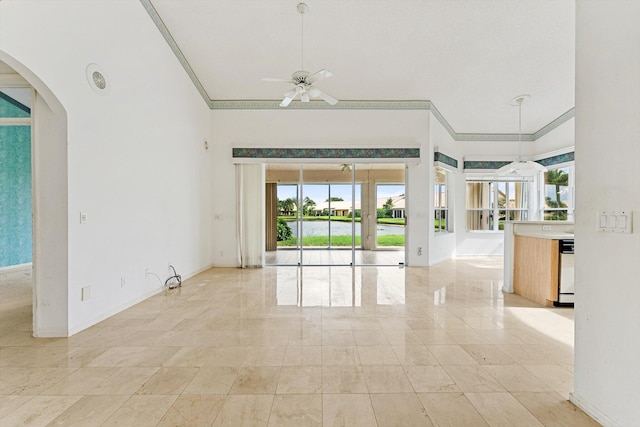 unfurnished room featuring ceiling fan, crown molding, and plenty of natural light