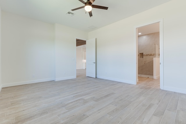 unfurnished bedroom with ceiling fan, ensuite bath, and light wood-type flooring