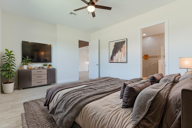 bedroom with ensuite bathroom, light wood-type flooring, and ceiling fan