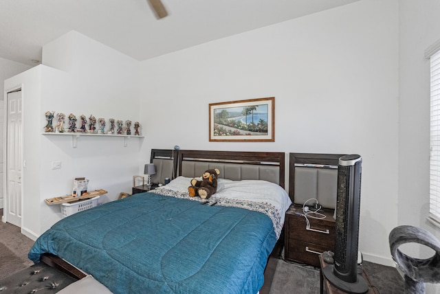 bedroom with ceiling fan and dark colored carpet