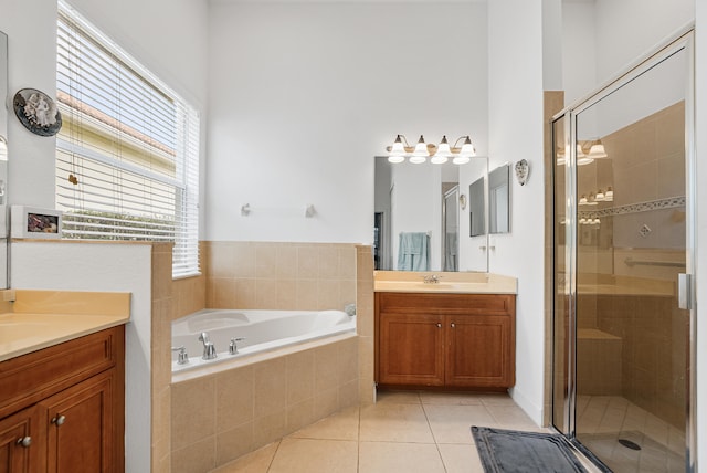 bathroom featuring vanity, tile patterned flooring, and plus walk in shower