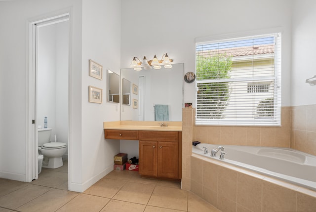 bathroom featuring tile patterned floors, tiled bath, toilet, and plenty of natural light