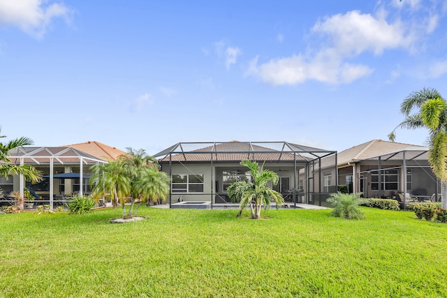 back of house with a lanai and a yard