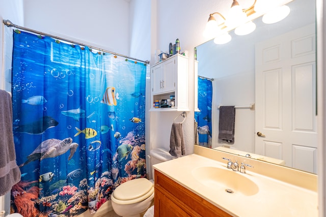 bathroom with vanity, toilet, and walk in shower