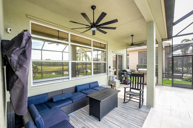 view of patio / terrace with glass enclosure, ceiling fan, grilling area, and an outdoor hangout area