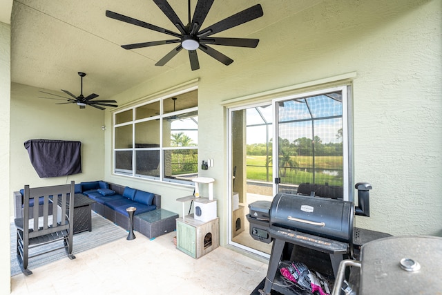 view of patio featuring glass enclosure, area for grilling, and an outdoor hangout area