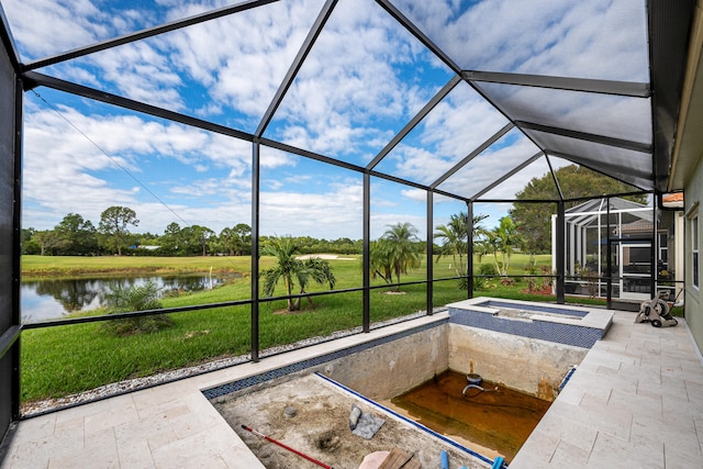 view of swimming pool featuring a lawn, glass enclosure, a patio area, an in ground hot tub, and a water view