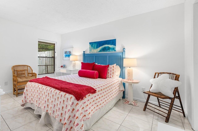 bedroom with a textured ceiling and tile patterned floors