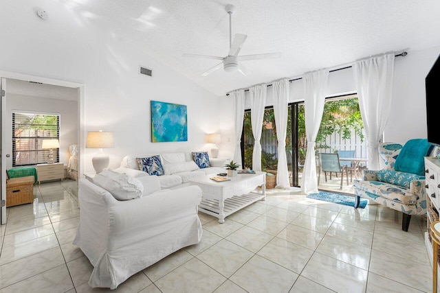 tiled living room featuring a textured ceiling, ceiling fan, and lofted ceiling