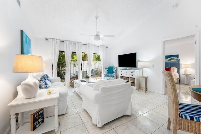 living room featuring ceiling fan, light tile patterned floors, a textured ceiling, and high vaulted ceiling