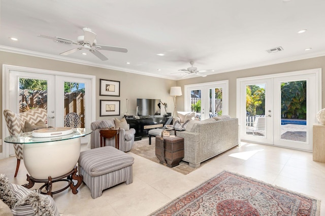 tiled living room with ceiling fan, french doors, plenty of natural light, and ornamental molding