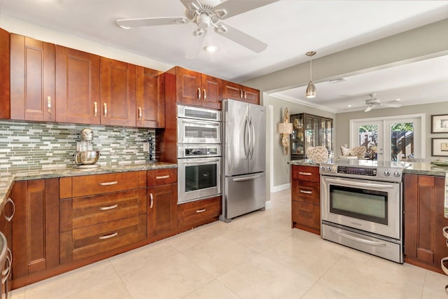 kitchen featuring decorative backsplash, crown molding, light stone countertops, and stainless steel appliances