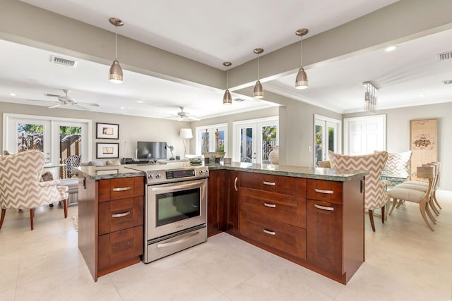 kitchen featuring a wealth of natural light, stainless steel range, french doors, and decorative light fixtures