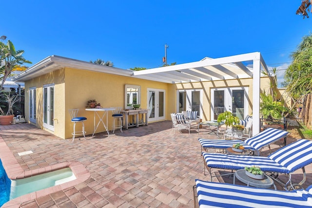 back of house featuring french doors, an outdoor hangout area, and a patio area