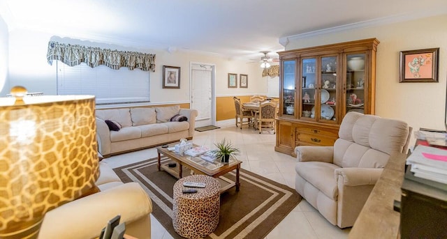 tiled living room with ceiling fan and crown molding