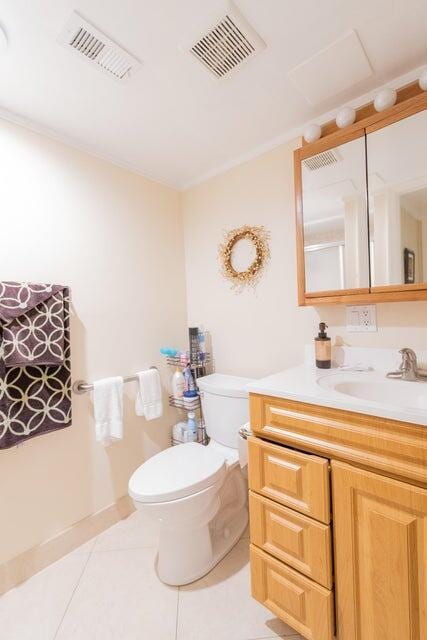 bathroom with tile patterned floors, vanity, and toilet