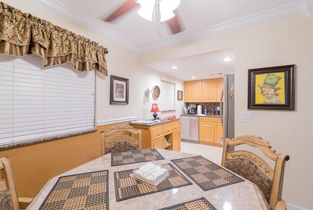 dining space with ceiling fan, sink, and ornamental molding