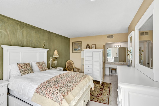 bedroom featuring sink and light tile patterned floors