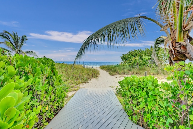 surrounding community featuring a beach view and a water view