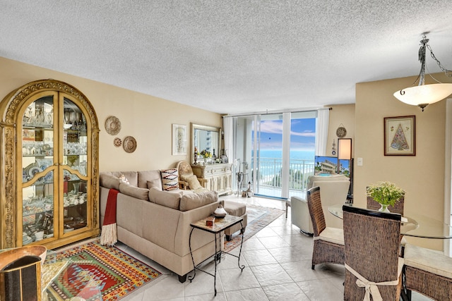 living room featuring floor to ceiling windows, a textured ceiling, and light tile patterned floors