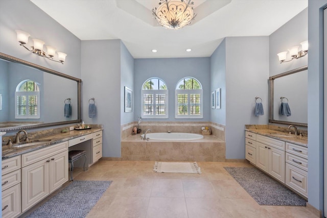 full bath with a garden tub, two vanities, a sink, and tile patterned floors