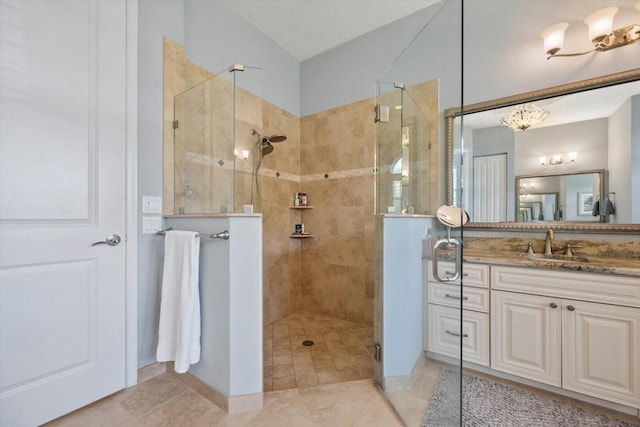 full bathroom featuring a textured ceiling, lofted ceiling, vanity, tile patterned floors, and a stall shower