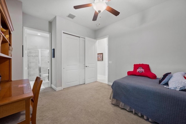 bedroom with light colored carpet, visible vents, baseboards, and ensuite bathroom