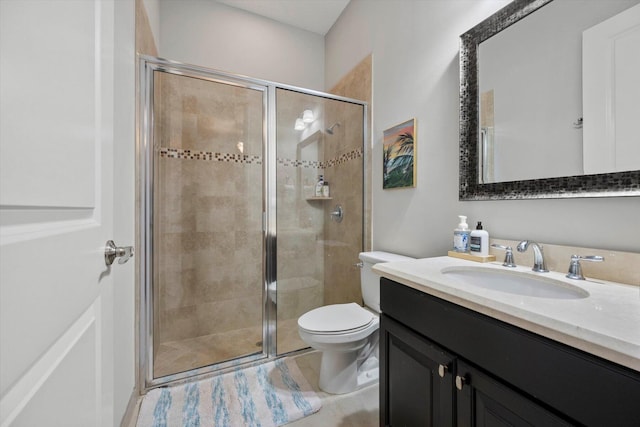 full bath with a stall shower, vanity, and toilet