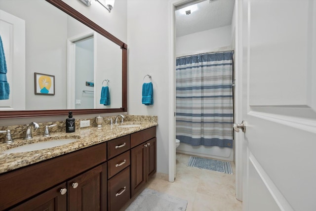 bathroom with vanity, a textured ceiling, and toilet