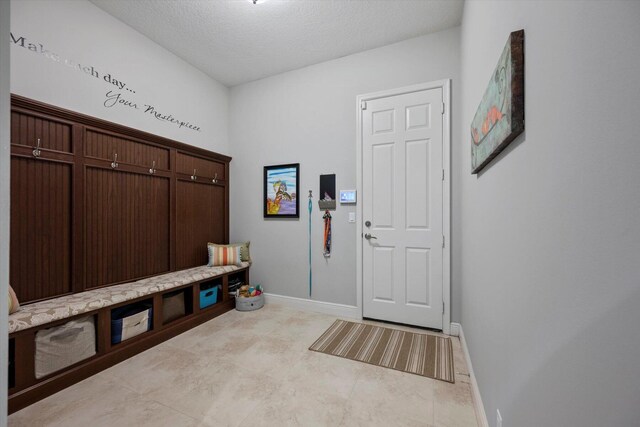 bathroom with a shower with door, vanity, tile patterned floors, and toilet