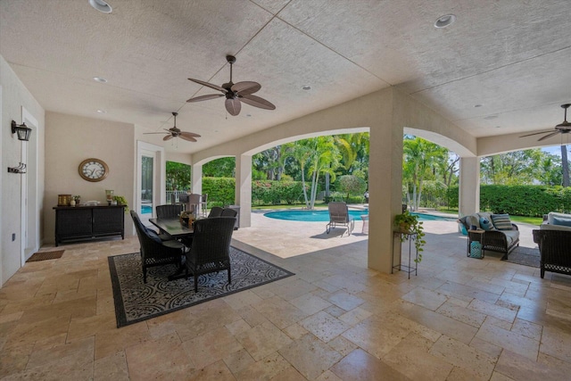 view of patio with an outdoor hangout area, ceiling fan, outdoor dining area, and a fenced in pool