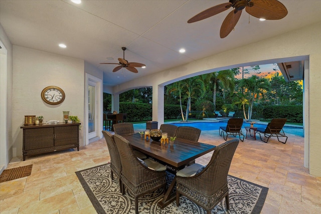 exterior space featuring a fenced in pool, a ceiling fan, and outdoor dining space