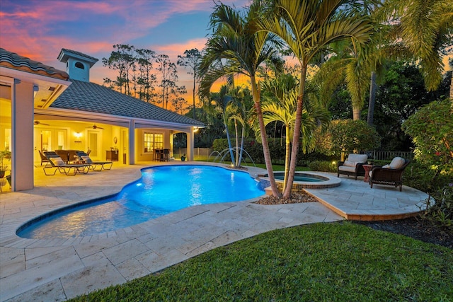 view of pool with a pool with connected hot tub, outdoor dining area, a ceiling fan, and a patio