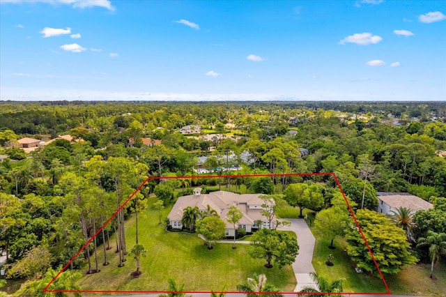 birds eye view of property with a view of trees