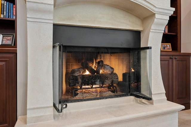 details featuring a lit fireplace