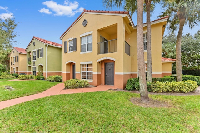 mediterranean / spanish-style home with a front yard