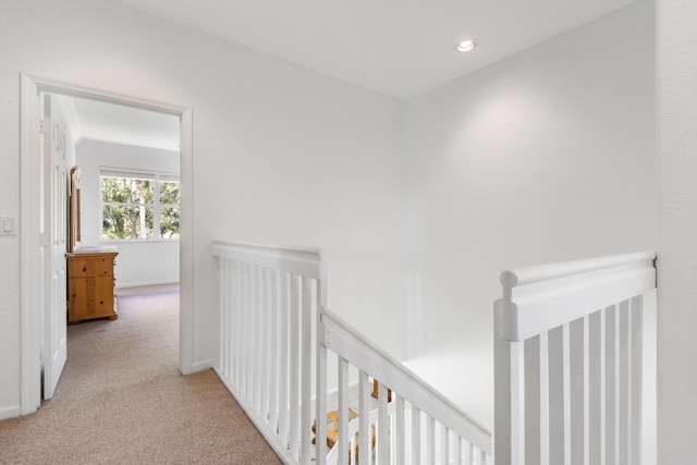 hall featuring light colored carpet