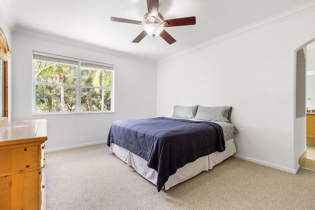 bedroom featuring light carpet, ceiling fan, and crown molding