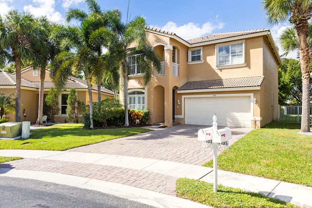 mediterranean / spanish-style home with a garage and a front lawn