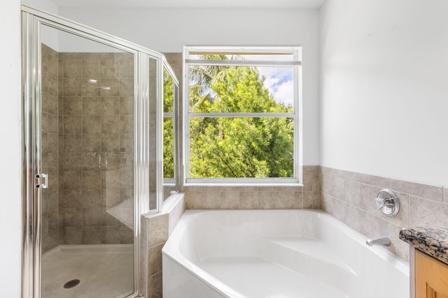 bathroom featuring independent shower and bath and vanity