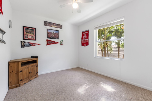 carpeted empty room with ceiling fan