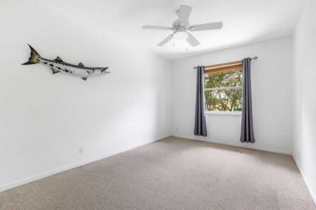 carpeted spare room featuring ceiling fan