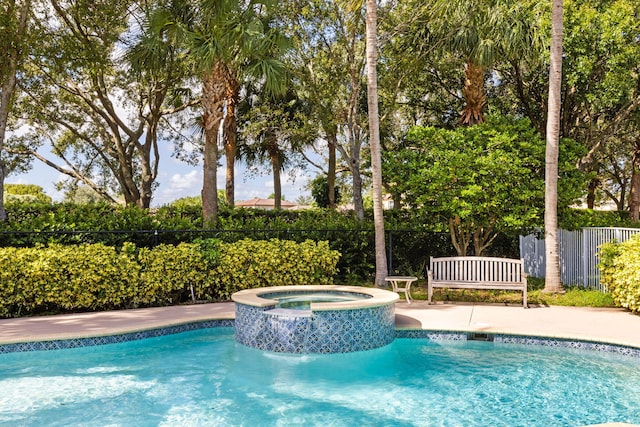 view of swimming pool featuring an in ground hot tub