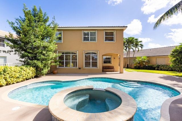 view of swimming pool featuring an in ground hot tub and a patio area