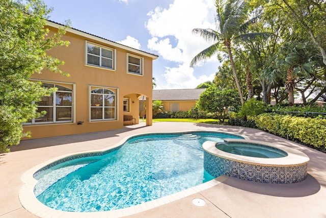 view of swimming pool featuring an in ground hot tub and a patio area